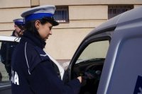 policjantka stoi przy kontrolowanym samochodzie